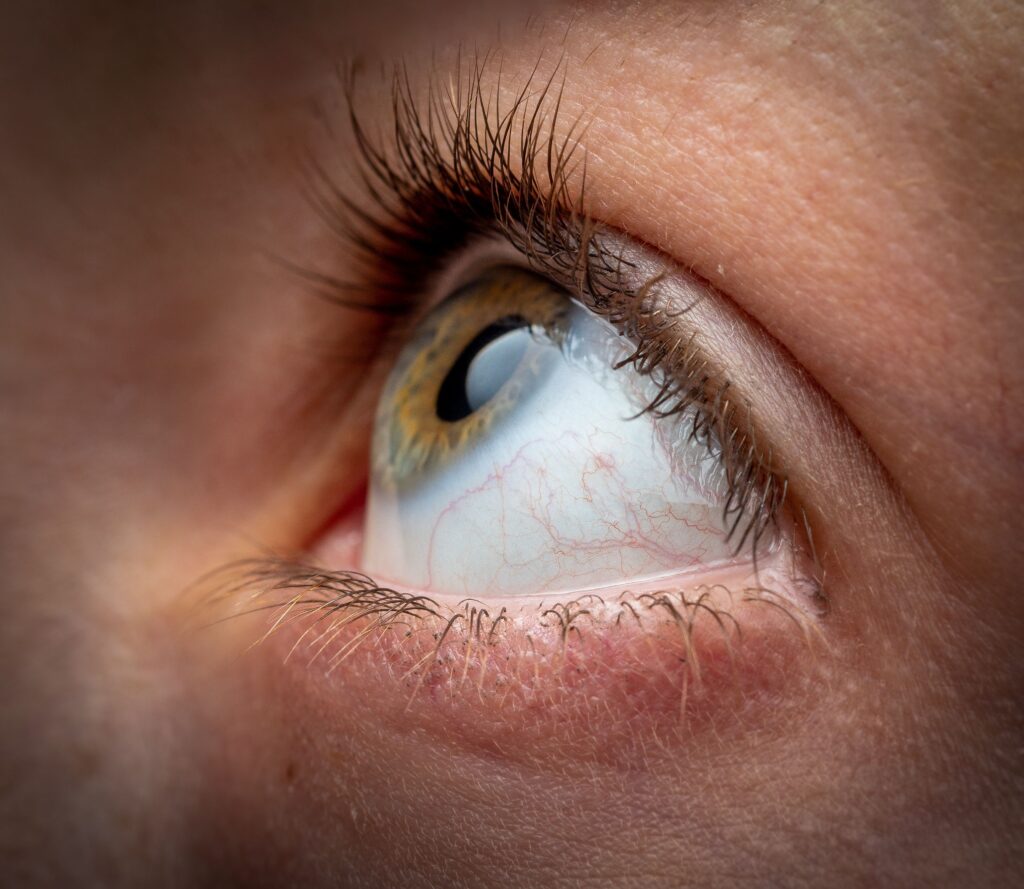 A macro shot of an eyeball of a person looking up